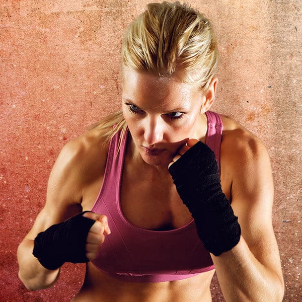 Mixed Martial Arts Lessons for Adults in Spring Hill KS - Lady Kickboxing Focused Background